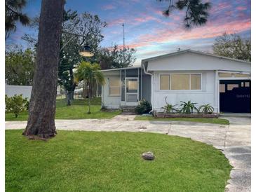 Charming home featuring a well-manicured lawn and a quaint, inviting entrance at 8219 Drew St, Englewood, FL 34224