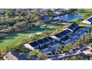 Beautiful aerial view of condo community with golf course and lush landscaping, offering a serene setting at 9570 High Gate Dr # 1722, Sarasota, FL 34238
