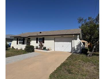 Charming single-story home featuring a well-maintained lawn and attached garage with ample parking space at 1036 Hope St, Venice, FL 34285