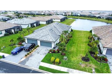Beautiful home with manicured lawn, three car garage, and stunning landscaping in a desirable community at 16111 Sunny Day Dr, Bradenton, FL 34211