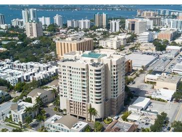 An aerial view of a high-rise building with a rooftop pool in a coastal city at 1771 Ringling Blvd # 902, Sarasota, FL 34236