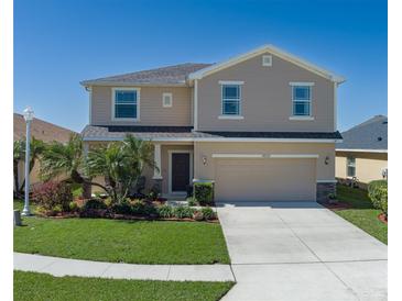 Charming two-story home with well-maintained lawn, two car garage and beautiful landscaping at 4509 Halls Mill Xing, Ellenton, FL 34222