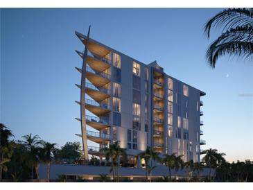 Modern luxury condo building featuring private balconies and lush tropical landscaping at 688 Golden Gate Point # 302, Sarasota, FL 34236