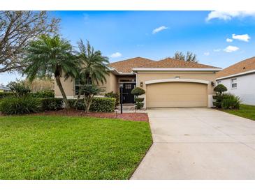 Charming single-story home with well-manicured lawn, mature trees, and a two-car garage at 12710 Rockrose Gln, Lakewood Ranch, FL 34202