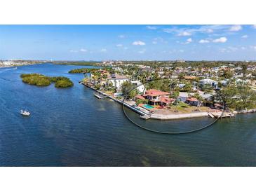 Stunning waterfront home with a pool and private dock, surrounded by lush landscaping at 1444 Ridgewood Ln, Sarasota, FL 34231