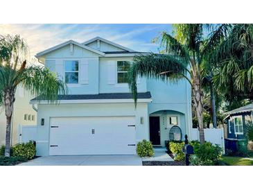 Charming two-story home with a well-maintained lawn, lush landscaping and two car garage at 2904 N Ola Ave, Tampa, FL 33602
