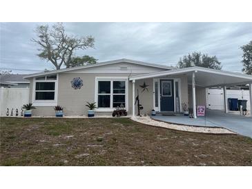 Charming single-story home with a covered carport and well-manicured lawn and landscaping at 3212 Florida Blvd, Bradenton, FL 34207