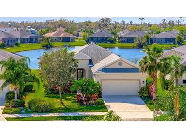 Beautiful single-Gathering home with lush landscaping, lake view and two car garage at 3838 Manorwood Loop, Parrish, FL 34219