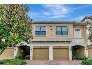 Charming two-story townhouse featuring a two-car garage and nicely landscaped front yard at 4210 Overture Cir, Bradenton, FL 34209