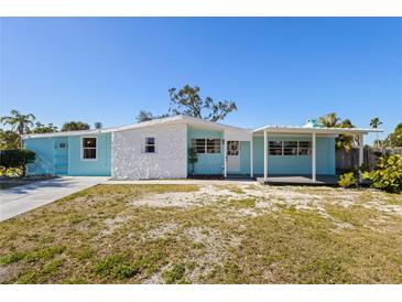 Charming single-story home with a light blue facade, white stone accents, and a covered front porch at 6520 Clemson St, Bradenton, FL 34207