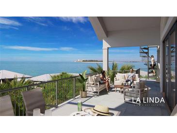 Expansive balcony with stunning ocean views, comfortable seating, and spiral staircase for elevated relaxation at 6924 Bochi Cir, Sarasota, FL 34242