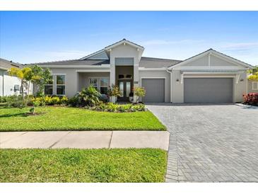 Beautiful single-story home with a well-manicured lawn and a two-car garage at 8227 Nevis Run, Bradenton, FL 34202