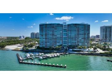 Stunning aerial view of waterfront condo with boat docks and tropical landscaping at 988 Blvd Of The Arts # 1209, Sarasota, FL 34236
