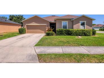 Charming single-story home with a well-manicured lawn and a two-car garage at 115 64Th E Ave, Bradenton, FL 34203
