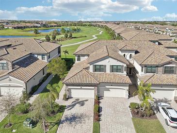 Stunning aerial view of homes overlooking the golf course and lake, showcasing a desirable community at 18117 Gawthrop Dr # 101, Lakewood Ranch, FL 34211