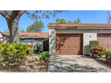 This home features a one-car garage with a brown door and well-maintained landscaping at 4423 Park Lake N Ter, Bradenton, FL 34209