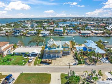 An aerial view of a canal front home showcasing its waterfront location and neighborhood at 525 68Th St St, Holmes Beach, FL 34217