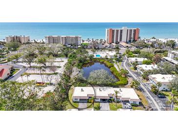 Real estate aerial view of houses, water feature, ocean, and buildings at 534 Sutton Pl, Longboat Key, FL 34228