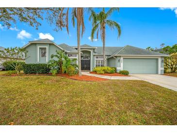 Charming single-story home with a well-manicured lawn and lush landscaping, creating curb appeal at 7604 49Th E Ave, Bradenton, FL 34203