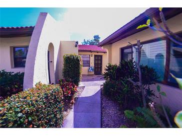 Charming front entrance featuring a walkway with lush landscaping and a cozy front door at 1412 56Th W St # 1412, Bradenton, FL 34209