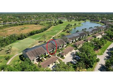 Beautiful aerial view of a condo community, golf course and lake at 5211 Mahogany Run # 113, Sarasota, FL 34241