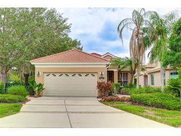 Charming single-story home with well-maintained landscaping, tile roof, and a two-car garage at 6103 Aviary Ct, Bradenton, FL 34203