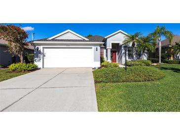 Charming single-story home with a well-manicured lawn and a two-car garage at 6642 Cheswick St, Sarasota, FL 34243