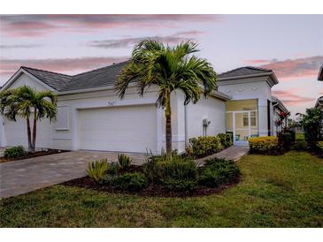 Charming single-story home featuring a well-maintained lawn, paver driveway, and a two-car garage at 7547 Campus Cv, Sarasota, FL 34243