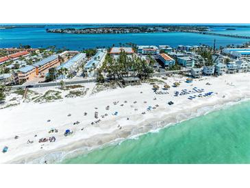 Beautiful aerial view of the white sandy beach and gulf coast with turquoise waters and beachfront community at 1325 Gulf Dr N # 247, Bradenton Beach, FL 34217