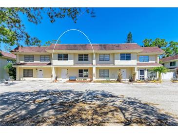 Inviting townhome with well-kept landscaping, neutral colors, and parking area at 3717 Delta St # 95, Sarasota, FL 34232