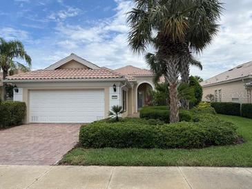 Charming single-story home featuring a tile roof, manicured landscaping, and a two-car garage at 5962 Roseto Pl, Sarasota, FL 34238