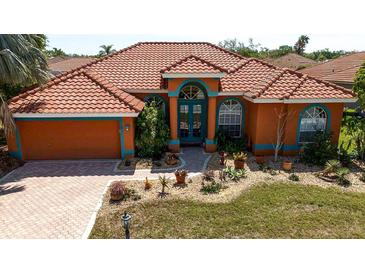 Inviting single-story home featuring terra cotta roofing and a well-manicured front yard at 7118 42Nd E Ct, Sarasota, FL 34243