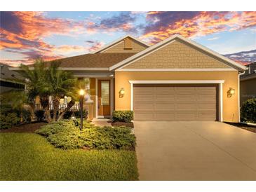 Charming single-story home boasts a well-manicured lawn and a two-car garage at 3835 Autumn Fern Ter, Sarasota, FL 34243