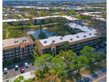 An aerial view of condos surrounded by lush trees and water features in a beautiful community at 425 30Th W Ave # C201, Bradenton, FL 34205