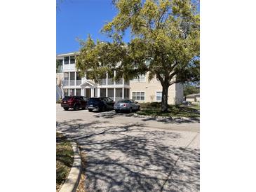 Three-story condo building with screened porches and parking for residents in a well-maintained community at 4802 51St W St # 1420, Bradenton, FL 34210