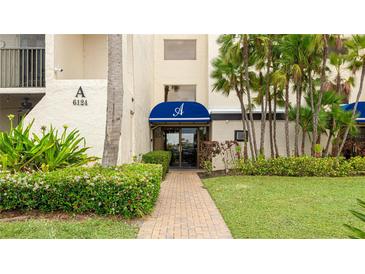 Welcoming entrance featuring well-maintained landscaping and a covered entryway at 6124 43Rd W St # 404A, Bradenton, FL 34210