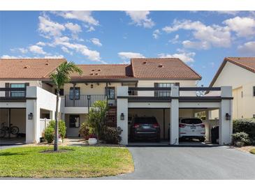 Inviting two-story condo featuring open carport and verdant landscaping at 756 Avenida Estancia # 162, Venice, FL 34292