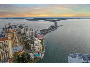 Stunning aerial view of condo building near the beach with a picturesque bay view at sunset at 101 Sunset Dr # 103, Sarasota, FL 34236