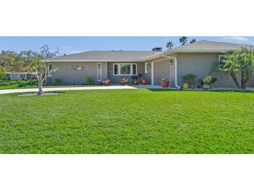 Well-maintained lawn leading up to a charming single-story home at 1208 Angela Maria Rd, Sarasota, FL 34243
