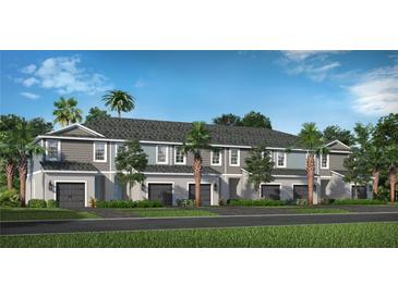 Charming townhouse exterior featuring attached garages, craftsman details, and beautiful landscaping at 2360 Washington Palm Ct, Bradenton, FL 34212