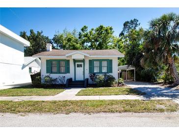 Charming single-story home with green shutters, a well-kept lawn, and mature trees at 2530 Loma Linda St, Sarasota, FL 34239