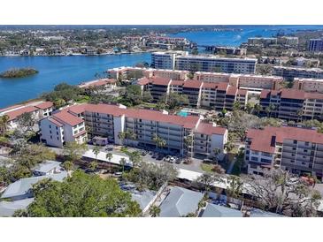 Stunning aerial view of waterfront condo complex with lush landscaping and breathtaking water views at 6285 Midnight Pass Rd # 201, Sarasota, FL 34242