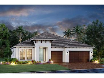 Elegant single-story home with a three-car garage, well-manicured landscaping, and a welcoming covered entrance at 7561 Nighthawk Dr, Sarasota, FL 34241