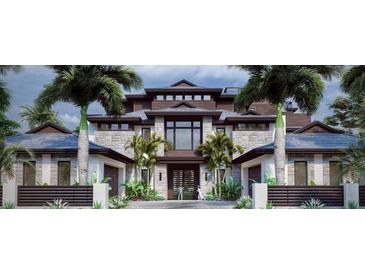 Stunning new construction, multi-story home featuring a stone facade, modern architectural design, and lush tropical landscaping at 821 S Bay Blvd, Anna Maria, FL 34216