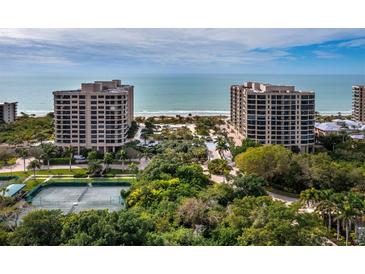 Stunning view of beachfront condos, tennis courts, lush landscaping, and sparkling ocean at 1211 Gulf Of Mexico Dr # 601, Longboat Key, FL 34228