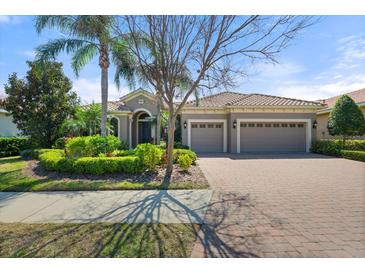 Charming single-story home with well-manicured landscaping and a three-car garage, perfect for curb appeal at 15508 Leven Links Pl, Lakewood Ranch, FL 34202
