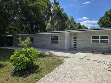 Charming single-story home with modern finishes, landscaped front yard and bright white stone entry walkway at 3234 Restful Ln, Sarasota, FL 34231