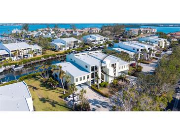 Waterfront condo building with boat access and luxurious tropical landscaping near the canal at 4104 128Th W St # 704, Cortez, FL 34215