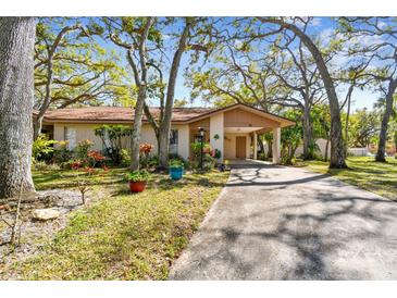 Charming single-story home featuring a carport, neutral paint, mature trees, and well-manicured landscaping at 5117 27Th W St # 5117, Bradenton, FL 34207