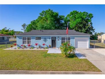 Charming single-story home featuring a manicured lawn and vibrant landscaping at 6639 Electra Ave, North Port, FL 34287